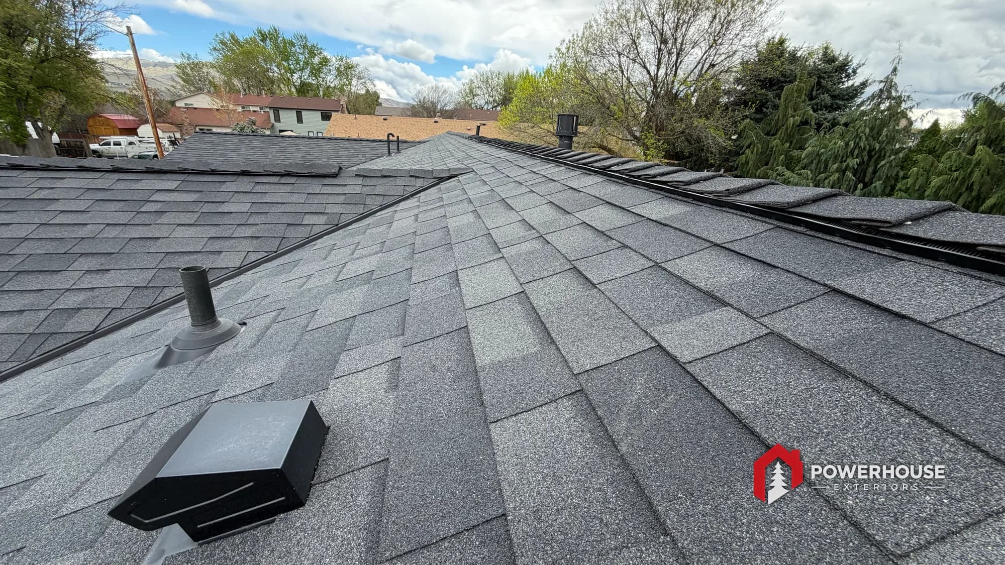 A completed dark architectural asphalt shingle roof by PowerHouse Exteriors in the Treasure Valley near Boise, Idaho.