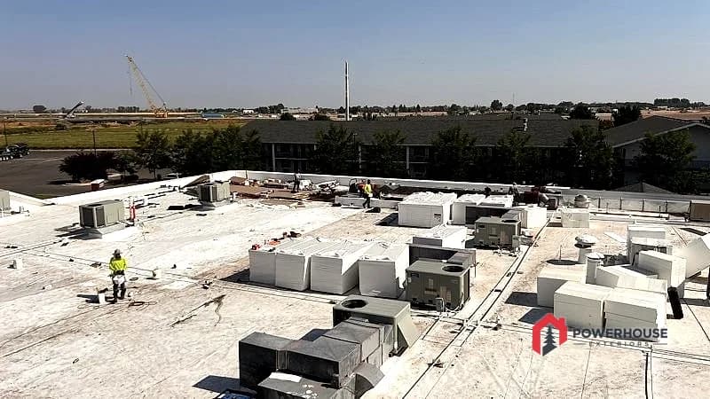 Completed commercial TPO roof replacement with reset HVAC units on a Best Western hotel