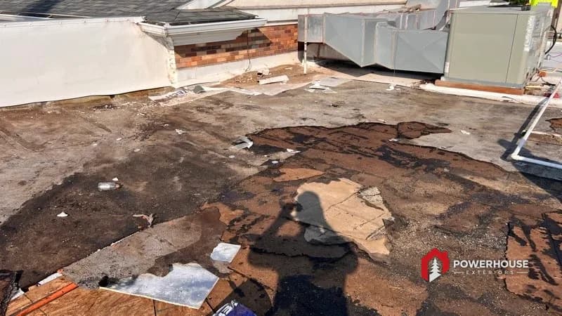 Tear-off of a storm-damaged commercial flat roof on a Best Western hotel