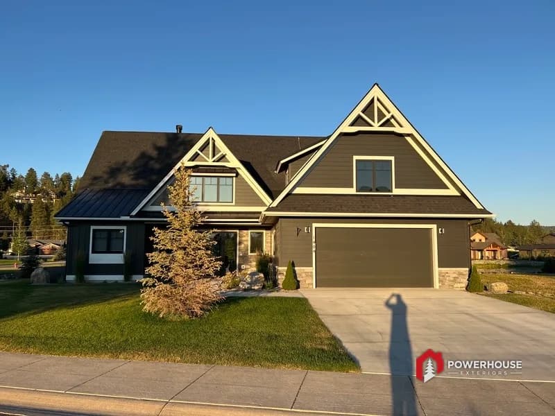Front elevation of a custom craftsman home roofed by PowerHouse Exteriors with shingle and standing-seam metal roofing