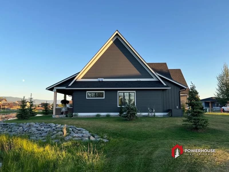 Steep decorative craftsman gable with architectural shingles and white trim