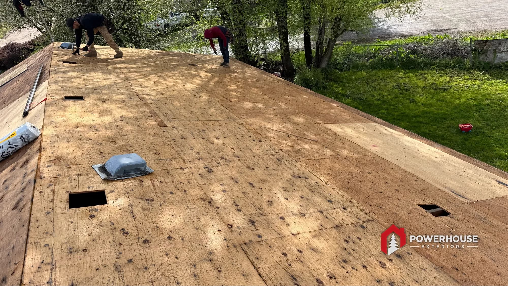 Exposed plywood roof deck with ventilation openings cut during a Boise roof replacement