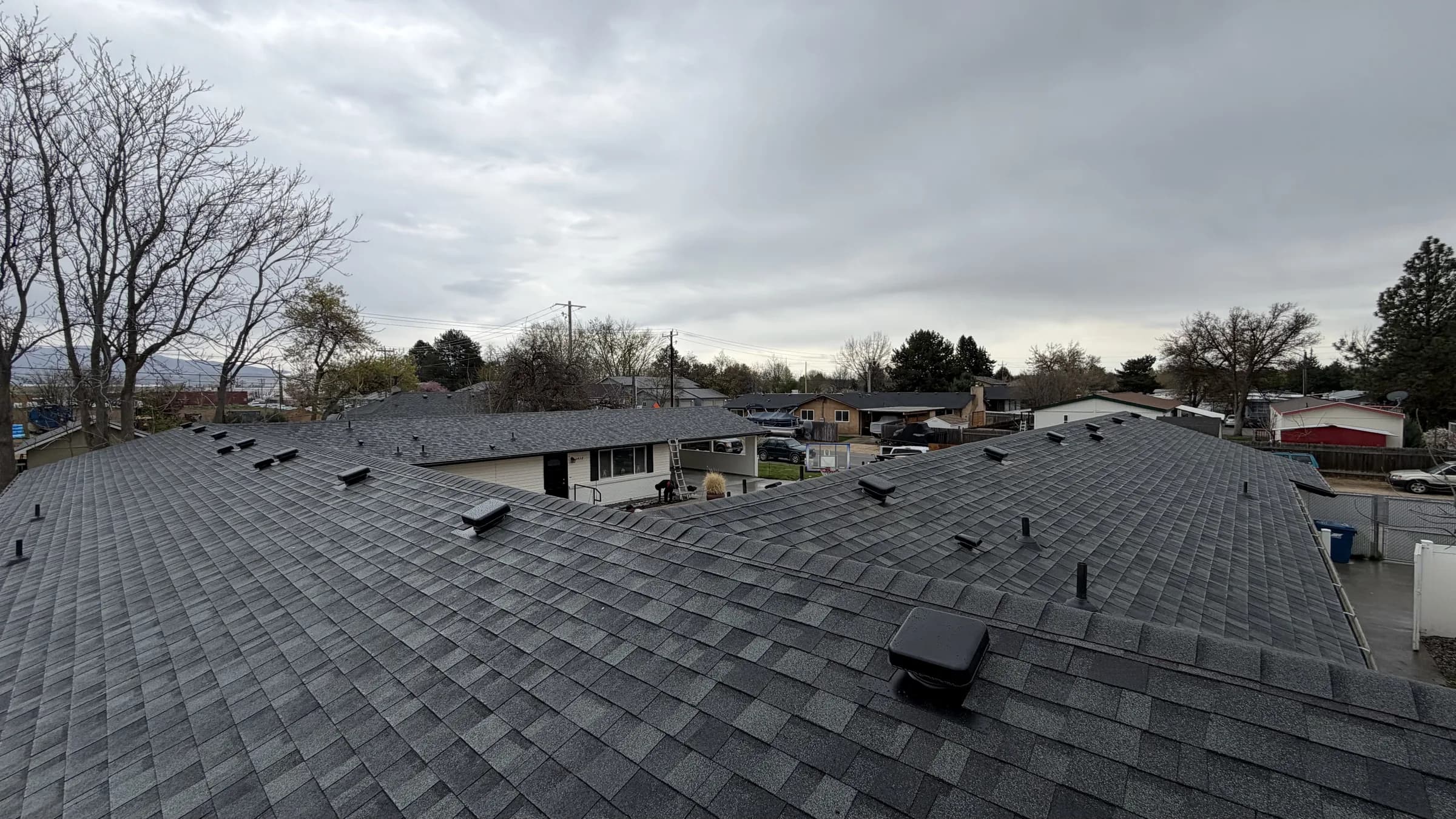 Wide view of completed connected roof sections at a Boise multifamily property