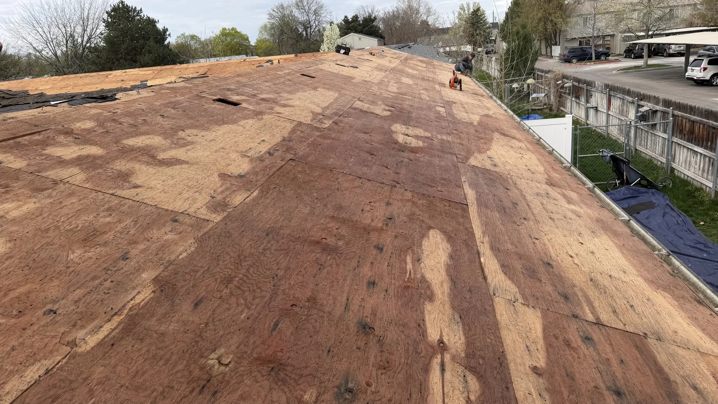Delaminated plywood roof decking exposed during Boise multifamily roof tear-off