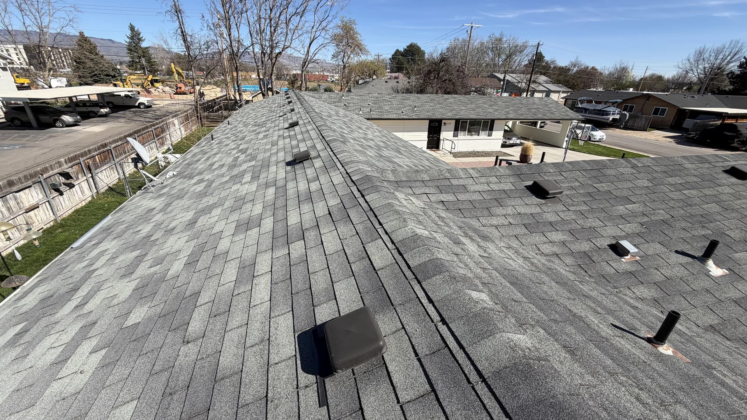 Existing architectural shingles across connected Boise multifamily roof sections