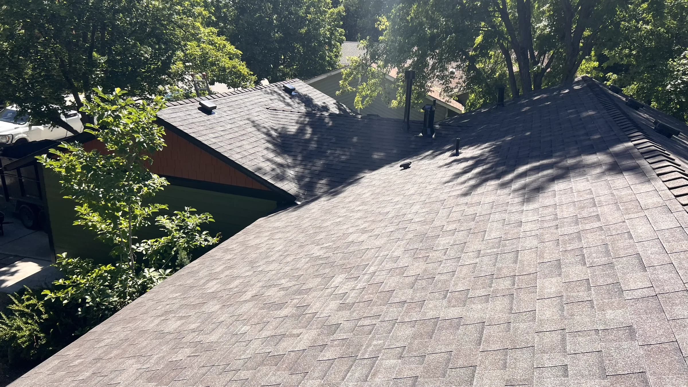 Completed architectural asphalt shingles across multiple roof sections on a Boise home