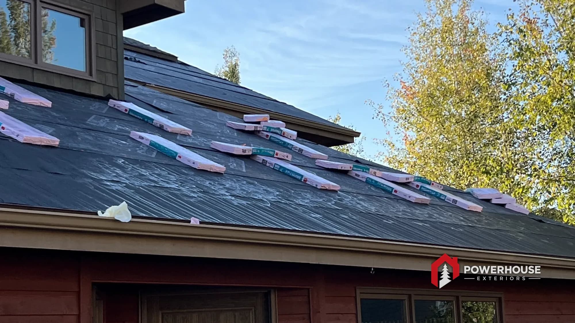 Impact-resistant architectural shingles being installed on a prepared roof deck