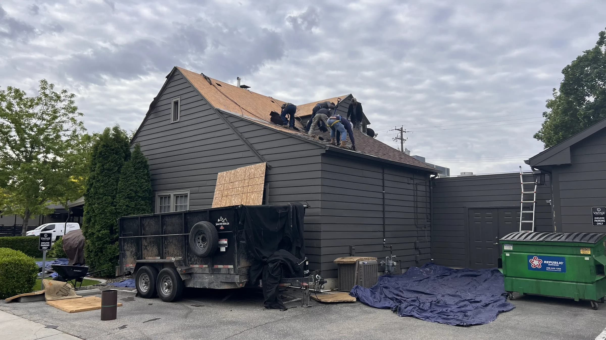 Commercial roofing crew removing existing shingles from the Vintage 61 restaurant roof in Meridian
