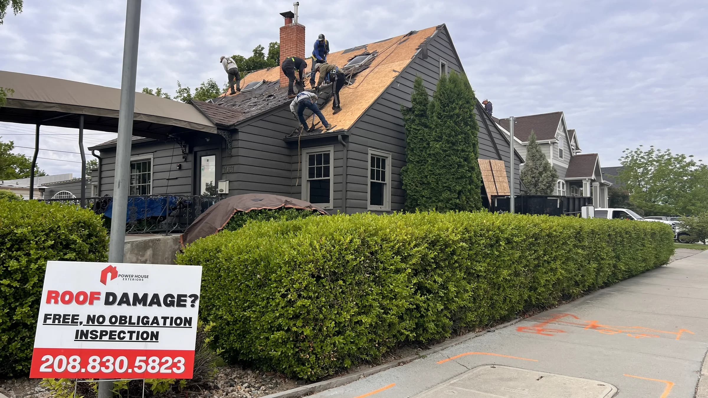 PowerHouse Exteriors crew performing roof tear-off at Vintage 61 in downtown Meridian