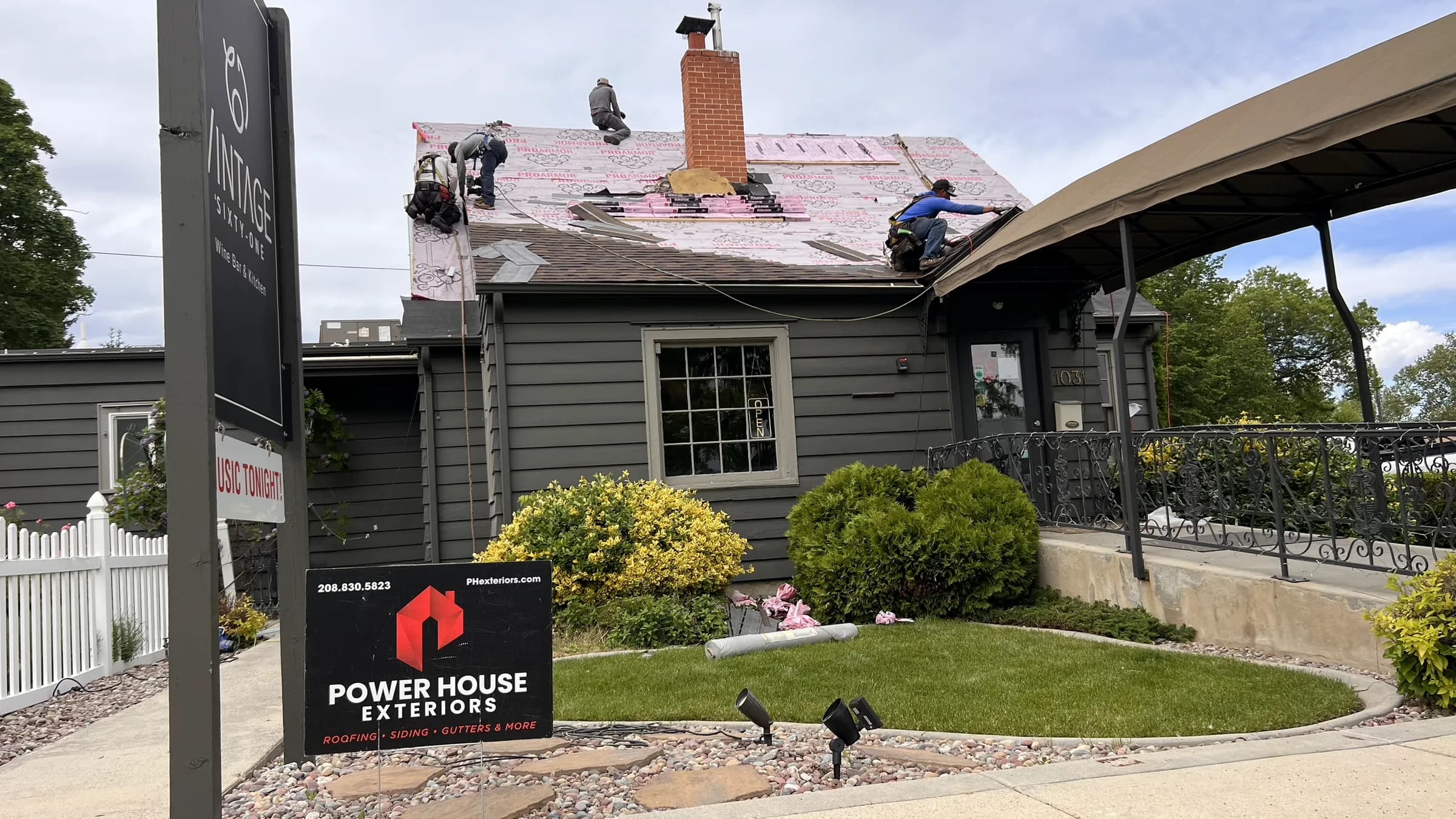 Architectural asphalt shingles being installed on the Vintage 61 commercial roof