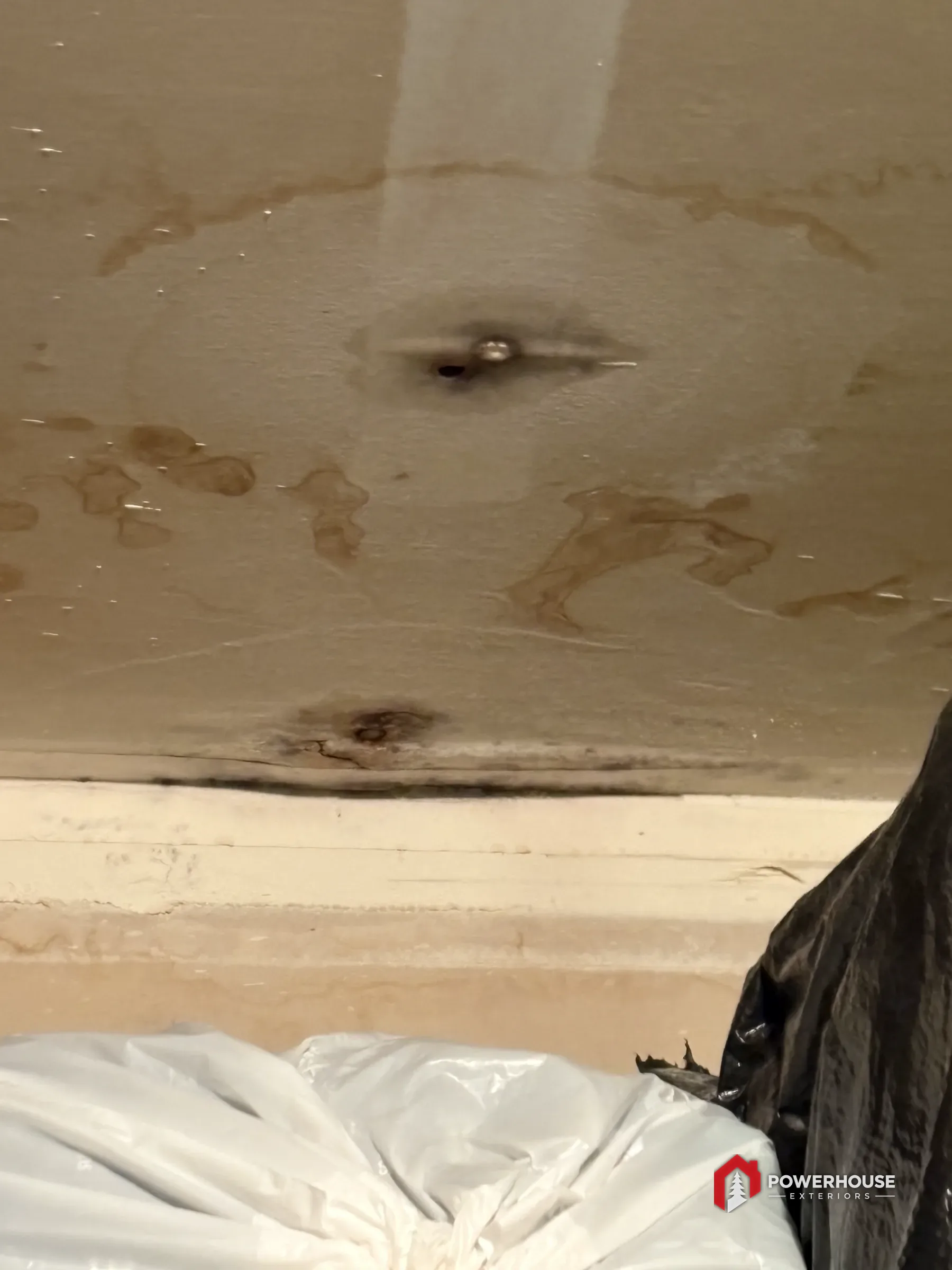 Water damage and staining on roof decking during a PowerHouse Exteriors inspection in the Treasure Valley.