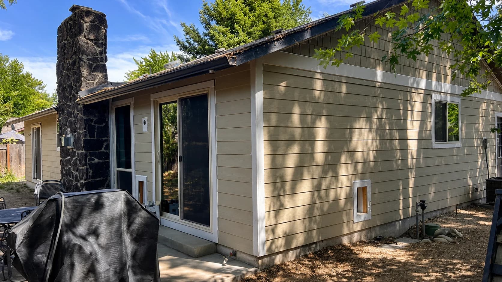 Completed Boise Residential Siding Renovation Completed tan lap siding renovation on a Boise home with a stone chimney.