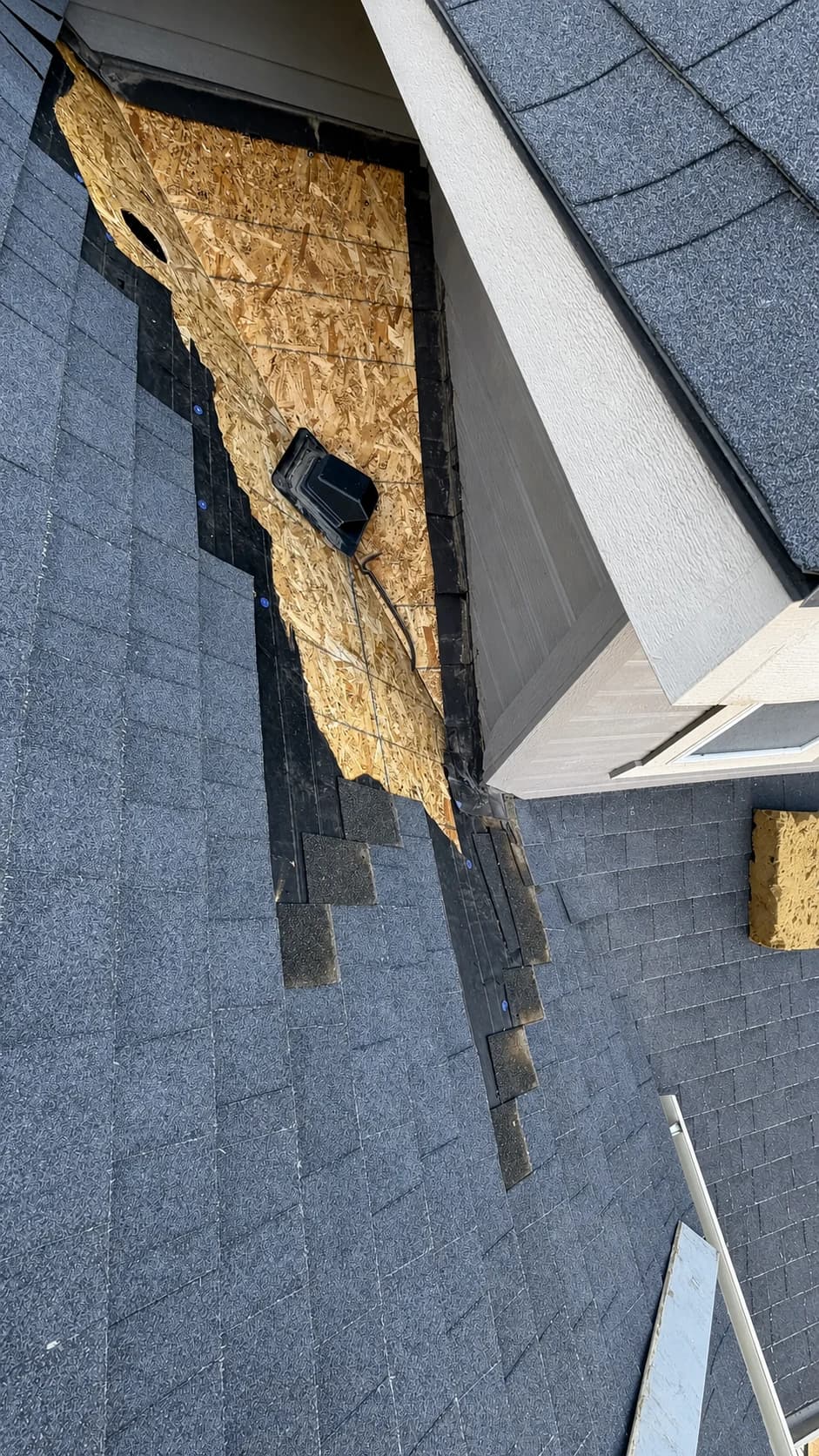 Treasure Valley Roof Damage Inspection Documentation Roof damage exposed during an inspection at a wall intersection on a Treasure Valley home.