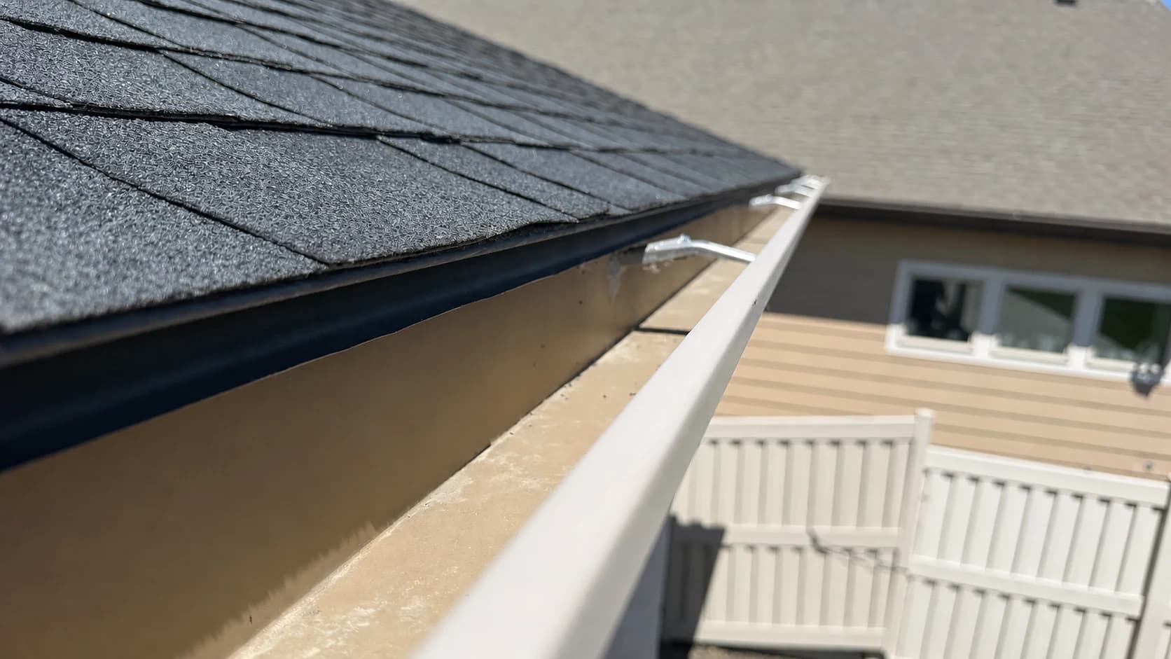 Treasure Valley Seamless Gutter and Roof Edge Close-up of a seamless gutter and asphalt shingle roof edge in the Treasure Valley.